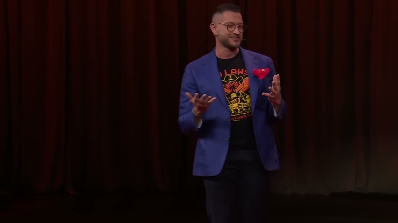 OpenClaw creator Peter Steinberger speaking on the TED stage in a blue jacket with a red lobster pocket square