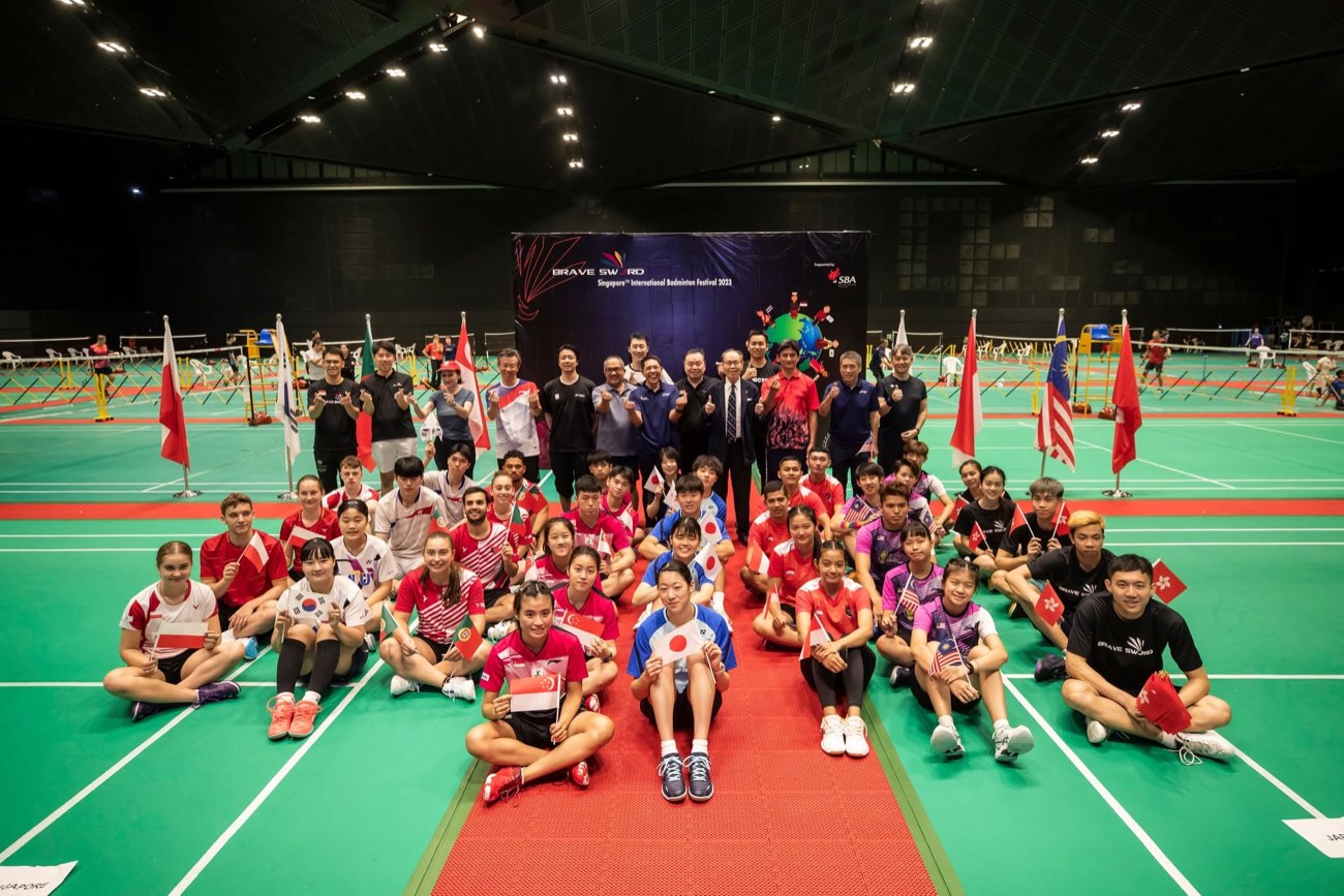 Players from many countries with national flags at the Singapore International Badminton Festival 2023