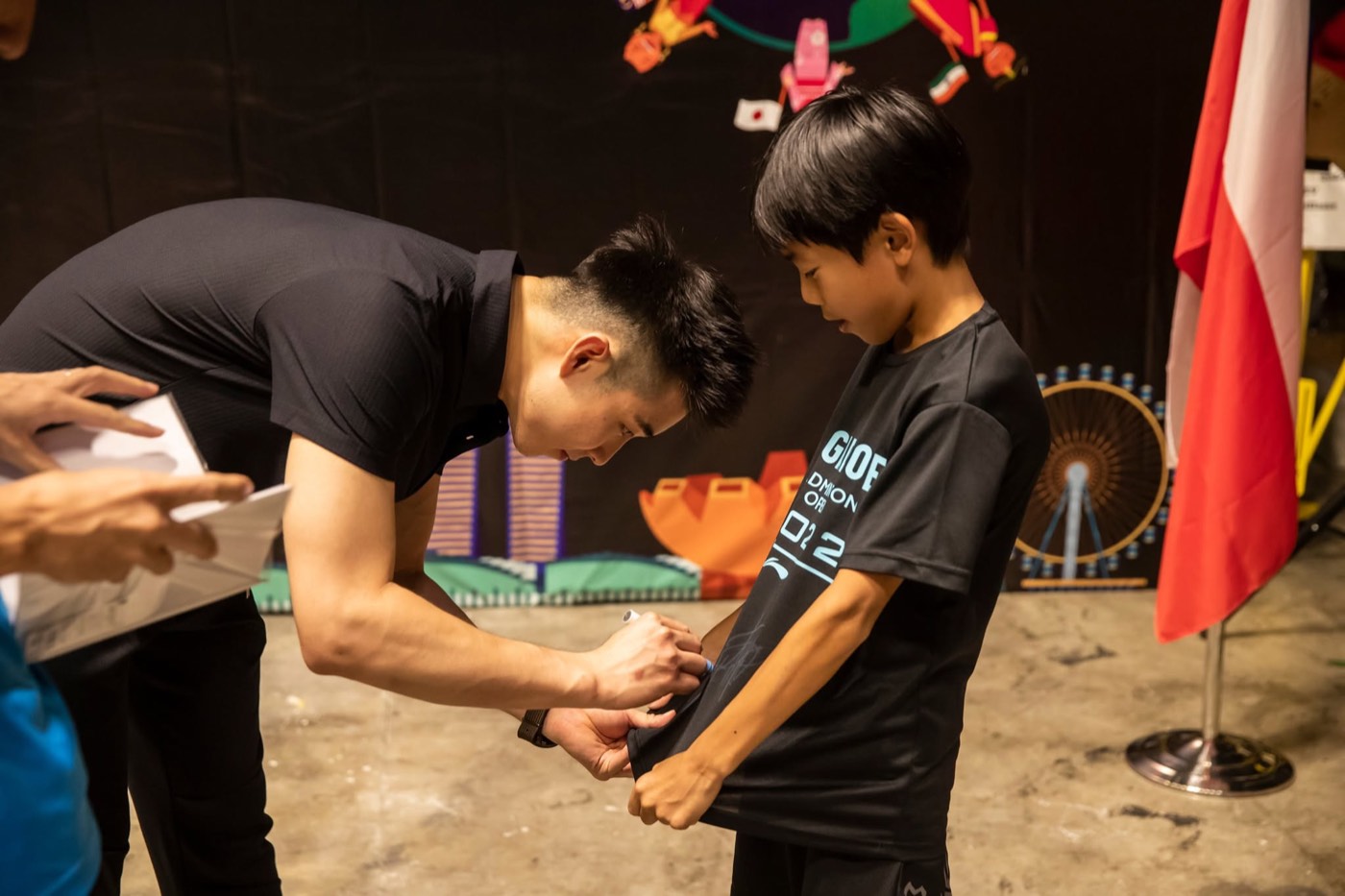 A national player signing a young player's shirt at the festival